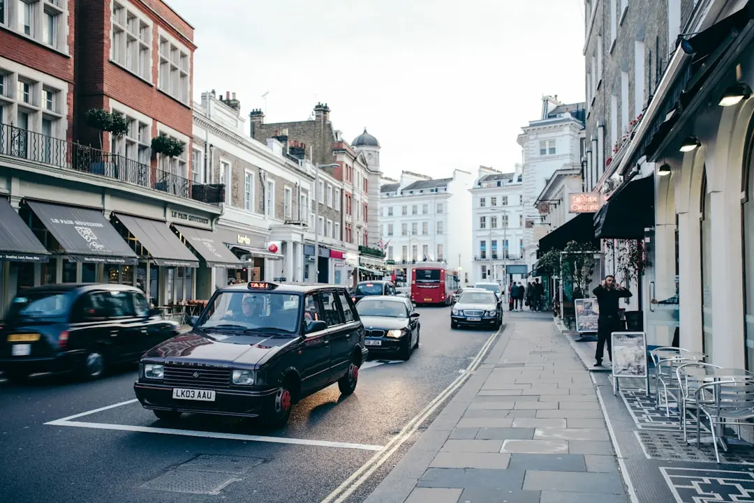 a city street filled with lots of traffic next to tall buildings — Photo by Francesco Zivoli on Unsplash