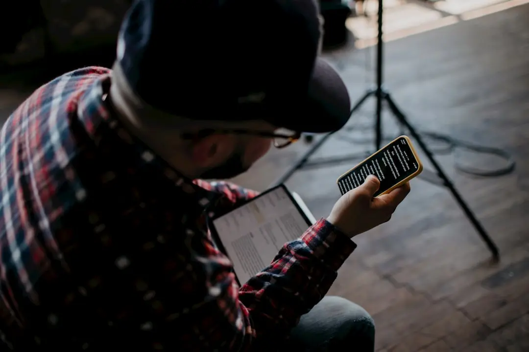 person in red and black plaid dress shirt holding white tablet computer — Photo by YouVersion on Unsplash