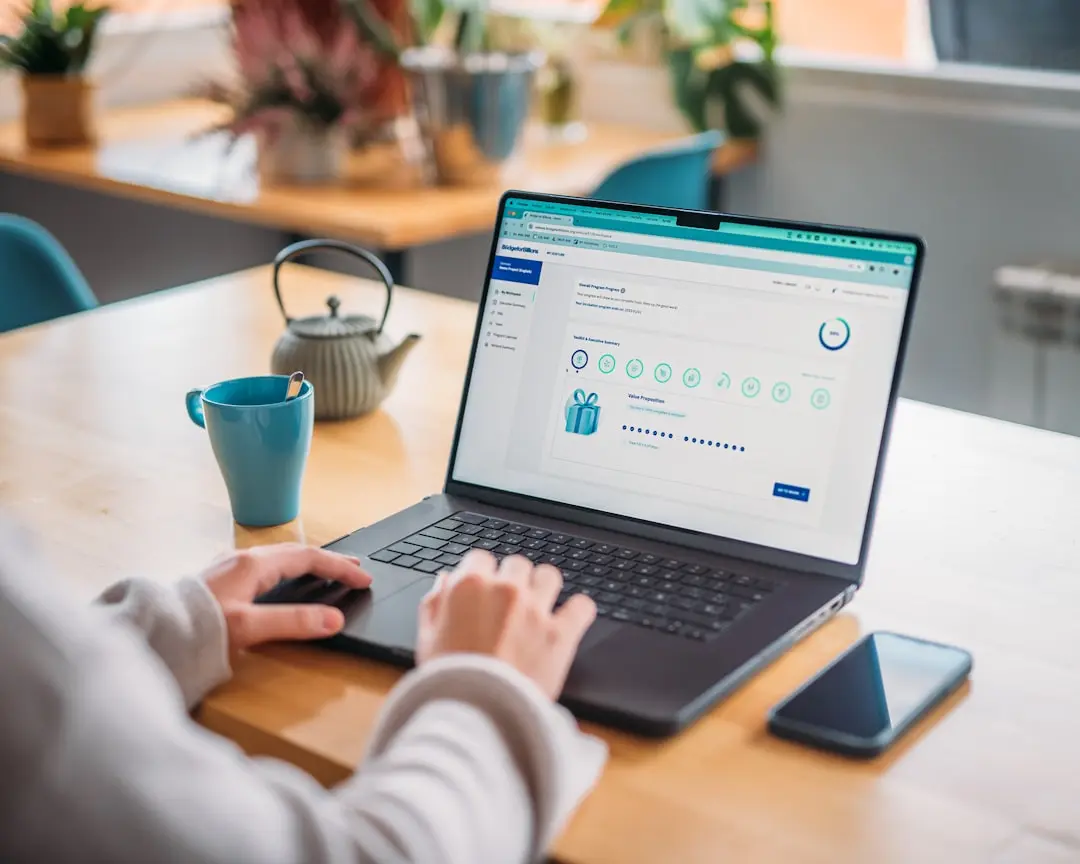 Person works on laptop at a desk with tea. — Photo by Bridge for Billions on Unsplash