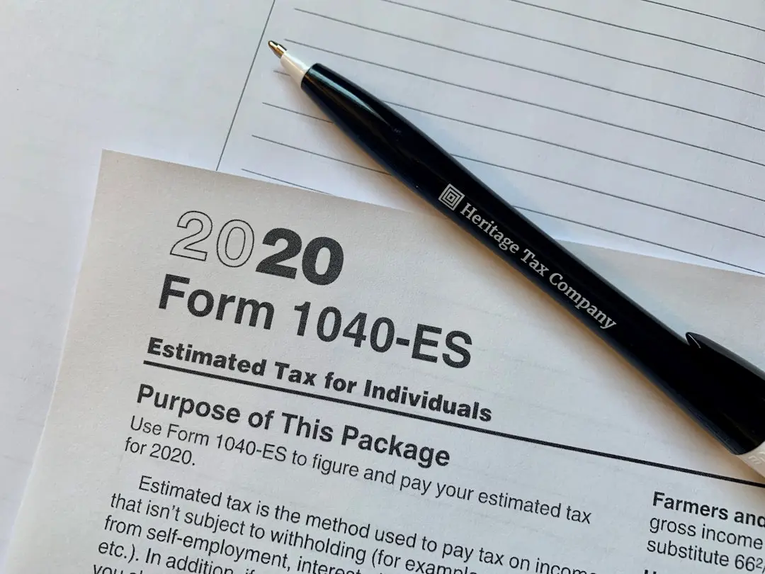 a pen sitting on top of a tax form — Photo by Rebekah Roy on Unsplash