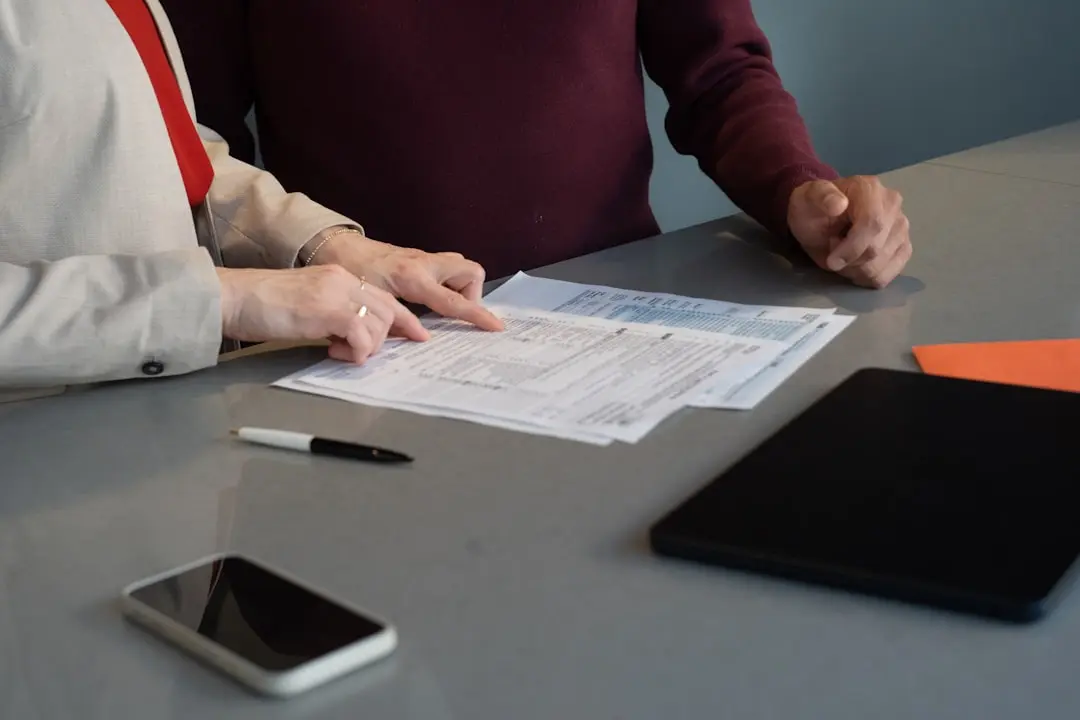 Two people reviewing documents at a table. — Photo by Olena Kholina on Unsplash