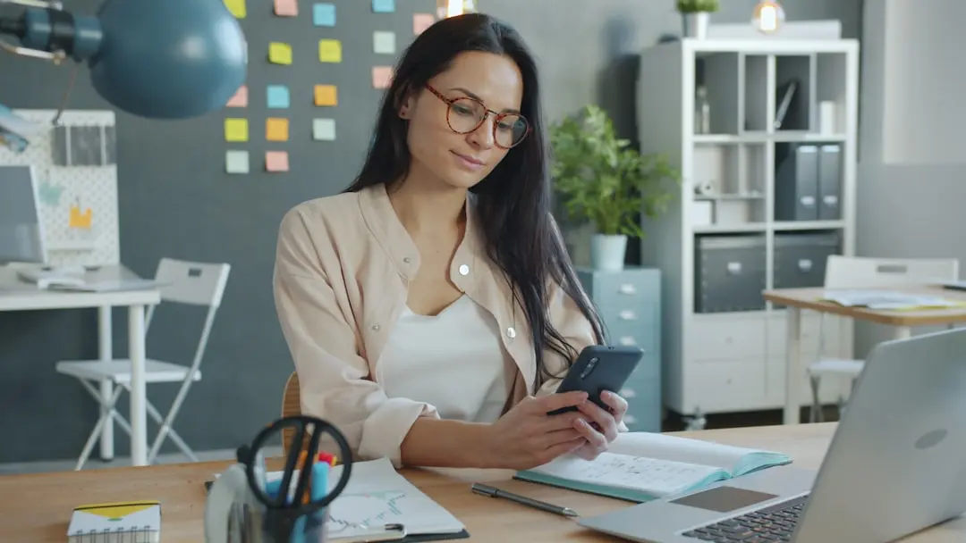 Woman working on a smartphone at her desk. — Photo by Vitaly Gariev on Unsplash