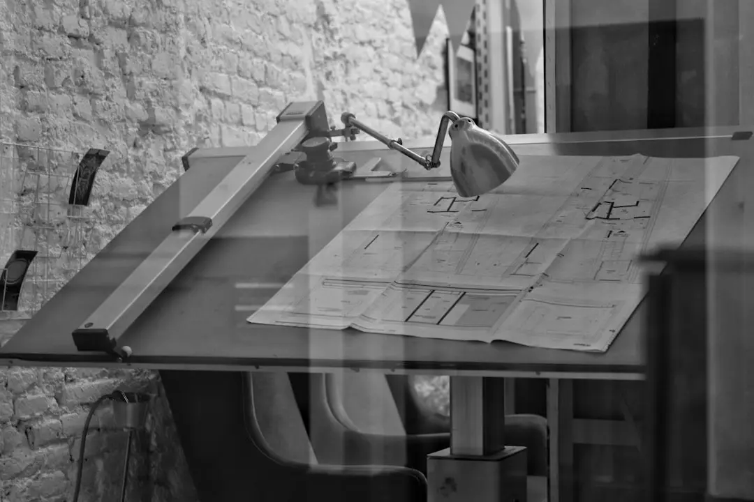 grayscale photo of chair and table — Photo by Tommy on Unsplash