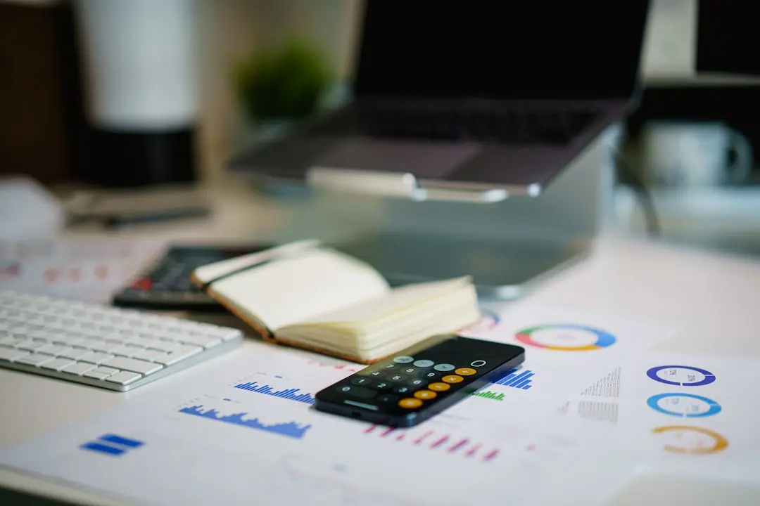 a remote control sitting on top of a table next to a book — Photo by Jakub Żerdzicki on Unsplash