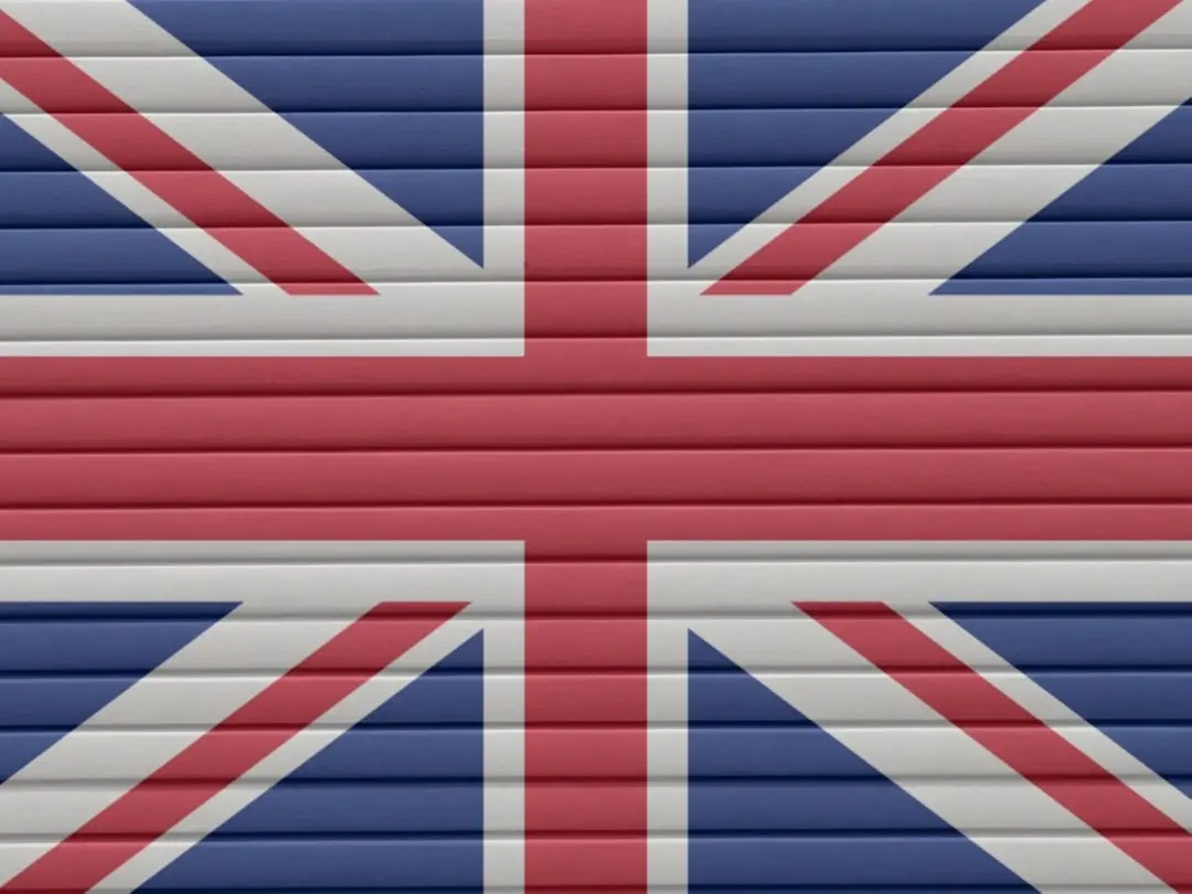 the british flag is painted on a garage door — Photo by Nancy Hughes on Unsplash