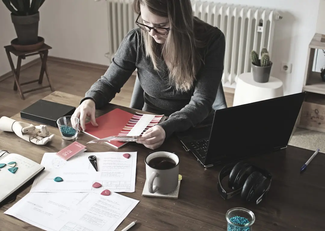 woman in gray long sleeve shirt sitting at the table — Photo by Rombo on Unsplash