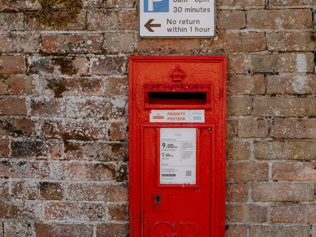 A red post box against a brick wall. — Photo by Annie Spratt on Unsplash