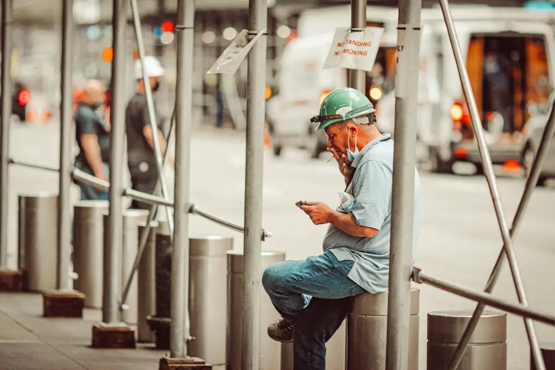 man in blue shirt and blue denim jeans wearing yellow helmet — Photo by Jon Tyson on Unsplash