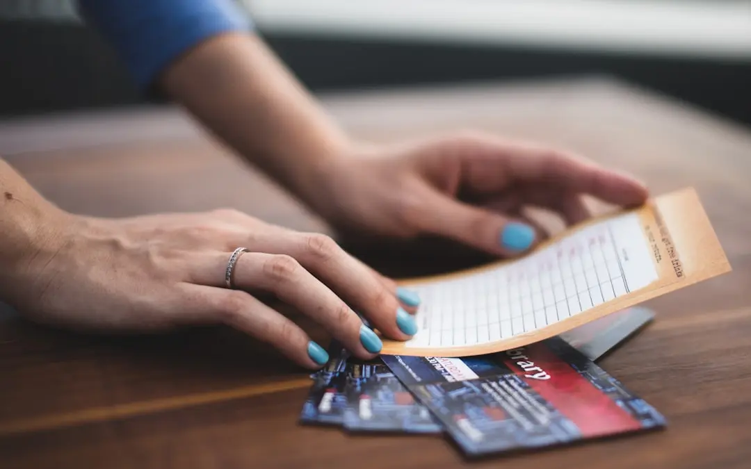 person reading card on three tickets — Photo by Anton Shuvalov on Unsplash