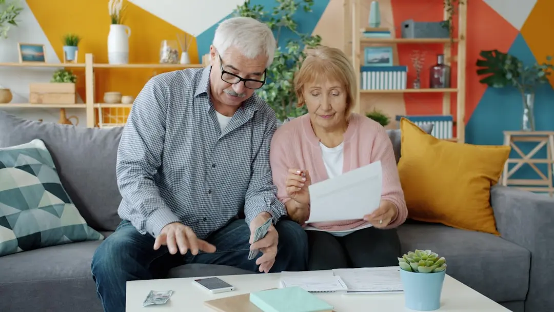 Elderly couple reviewing documents at home — Photo by Vitaly Gariev on Unsplash