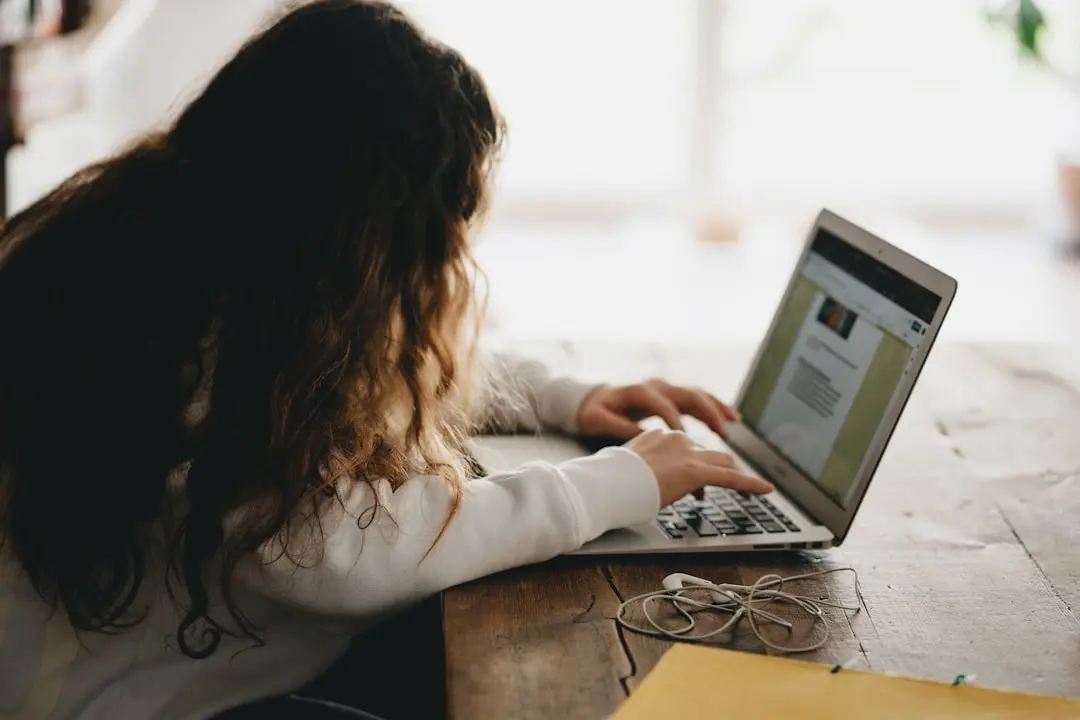 woman in white long sleeve shirt using macbook pro — Photo by Annie Spratt on Unsplash