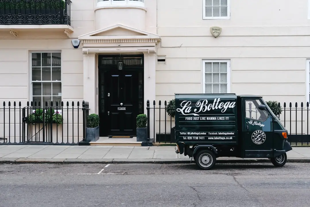black autographed parked near white concrete building — Photo by Aaina Sharma on Unsplash
