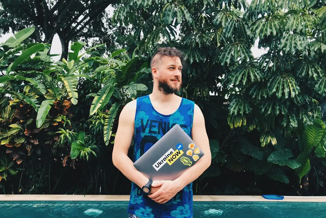 man wearing blue tank top near green tree — Photo by Max Kukurudziak on Unsplash
