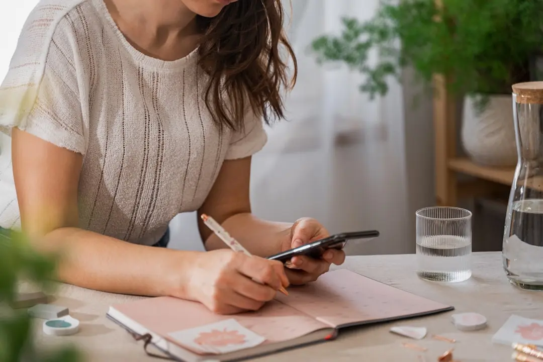 a woman writing on a piece of paper — Photo by Svitlana on Unsplash