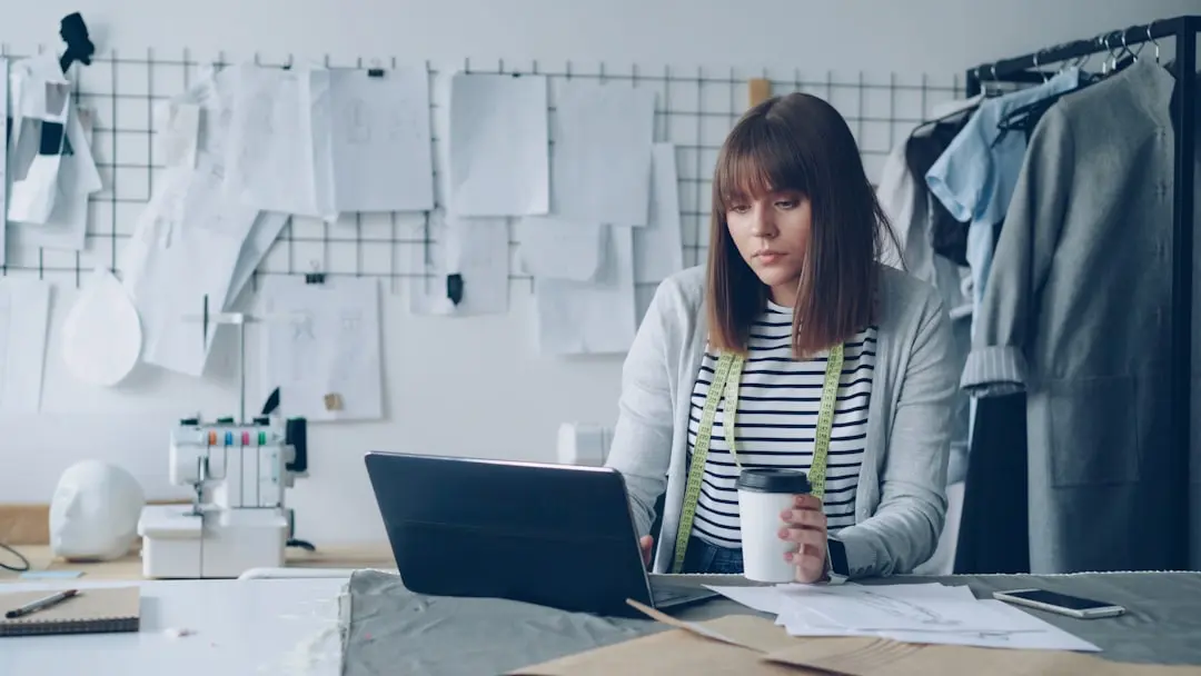 Fashion designer working on her laptop and sipping coffee. — Photo by Vitaly Gariev on Unsplash