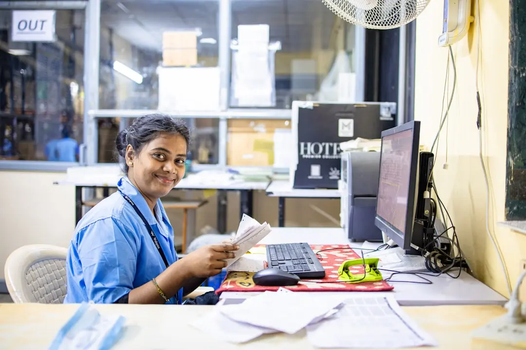 A woman sits at a desk, working. — Photo by EqualStock on Unsplash