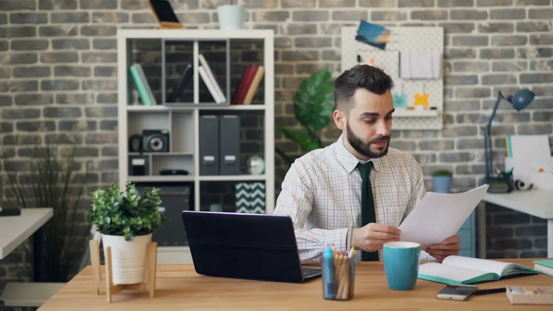 a man sitting at a desk in front of a laptop — Photo by Vitaly Gariev on Unsplash