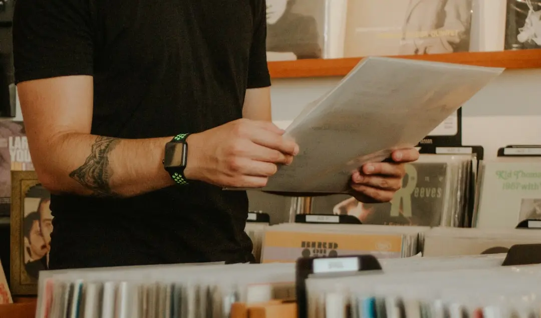 person in black long sleeve shirt holding white paper — Photo by Sebastian Cyrman on Unsplash