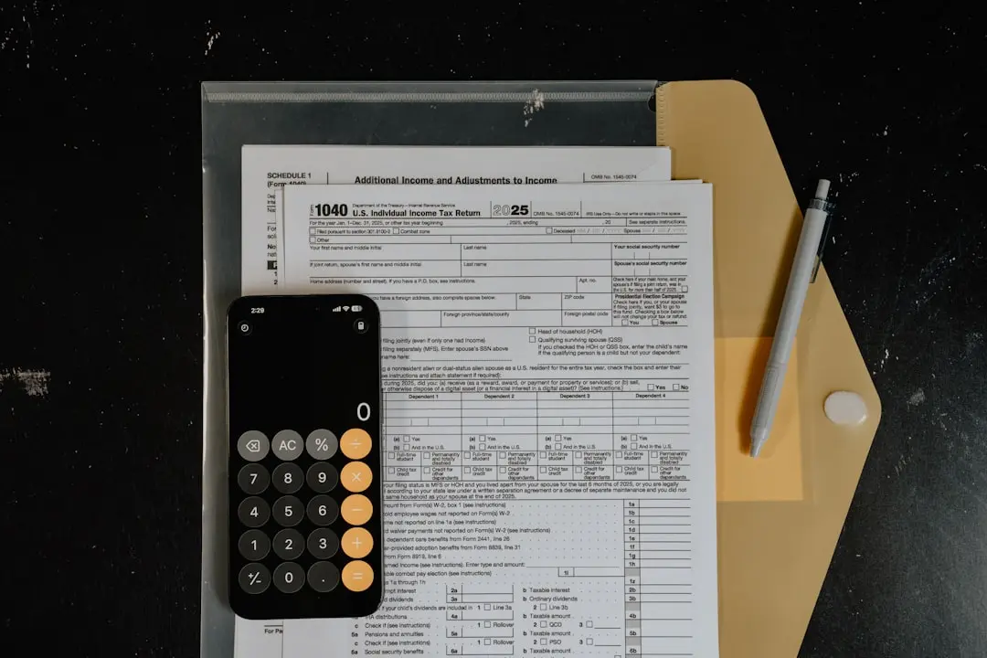 Calculator and pen on tax forms — Photo by Kelly Sikkema on Unsplash